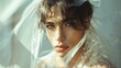 A young male face is softly framed by an exquisitely embroidered veil, his eyes conveying a story of youthful hope and romance. Gay marriage. LGBTQ community. Man wearing a veil