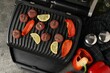 Electric grill with meat balls, bell peppers and lemon on grey table, flat lay