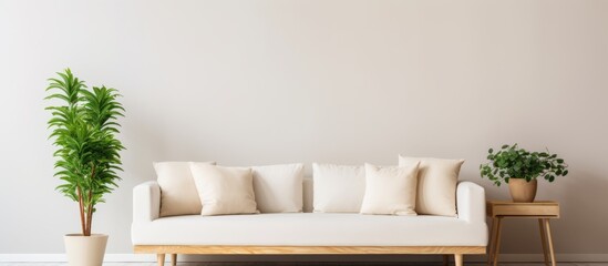 Poster - A cozy living room setting featuring a white couch adorned with cushions and a decorative plant