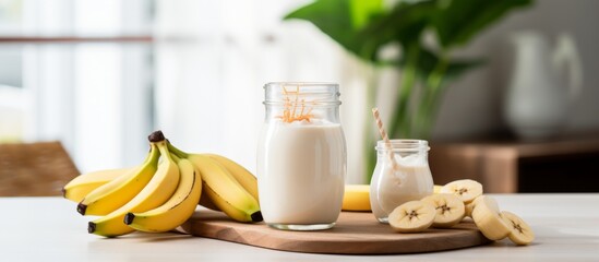 Canvas Print - Fresh ripe bananas and a bottle of milk placed on a wooden cutting board on a table
