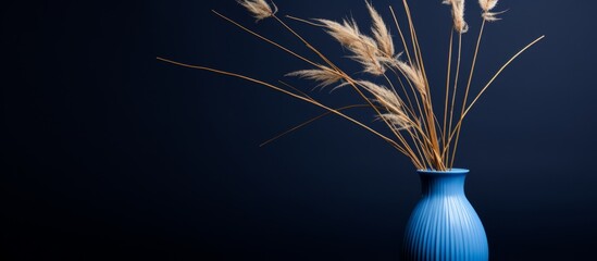 Canvas Print - A transparent vase filled with long green grass stems standing upright