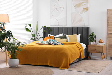 Wall Mural - Bright plaid and colorful pillows on bed in stylish bedroom. Interior design