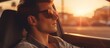 © AkuAku - A man with dark sunglasses is sitting inside a car, appearing stylish and cool