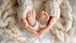 © JW Studio - Mother hands holding new born baby feet form a heart shape, concept of happy family, new birth baby happiness, Mom and child.