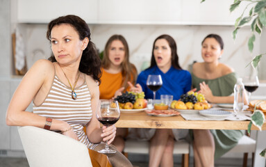 Wall Mural - Group of women friends quarrel with adult woman at house party in kitchen