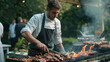 Attractive BBQ Chef Cooking Delicious Food at Outdoor Catered Event