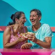 © Breezze - Hispanic couple laughing with giant dessert, colorful and playful food festival moment