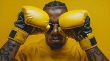 Vision Of Strength: Boxer In Yellow, Eyes Shielded With Gloves, Ready For Combat In A Striking Monochromatic Setting