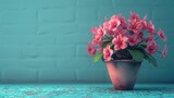 Fototapeta Dmuchawce -   A close-up of a potted plant with pink flowers on a table against a brick wall background