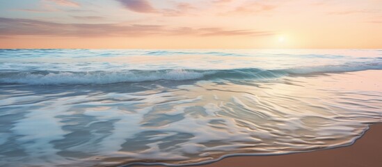 Poster - The sun setting over the ocean, painting the sky with warm colors, as waves gently crash onto the sandy shore