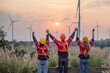 engineer technician team raise joy hand for success happiness at wind power plant machine . silhouette Group of colleague technician professional worker discussion maintenance electronic wind turbine