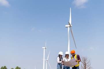 engineer team inspection check control wind power machine construction installation in wind energy factory. technician professional worker discussion check for maintenance electronic wind turbine