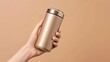 A reusable tan travel mug held by a girl against a neutral background. Monochromatic. Zero waste theme.