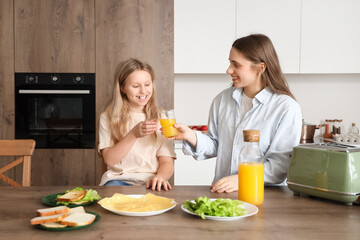 Sticker - Mother giving her little daughter juice with toasts in kitchen