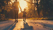 Mother holds child's hand, running in park as sun sets, creating a beautiful moment of joy and togetherness.