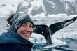Woman's beaming smile as they marvel at the sight of a whale's tail breaking the surface of the cold sea, the sense of wonder and awe reflected in their expression, creating a captivating