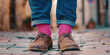 Man feet shoes and jeans, wearing pink socks. Self-expression, gender equality, equal rights, being yourself, gender stereotypes concept