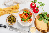 Fototapeta Kwiaty - italian pasta with tomato and capers