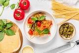 Fototapeta Kwiaty - italian pasta with tomato and capers