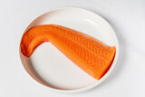 Fototapeta Tulipany - salmon fillet on the white plate