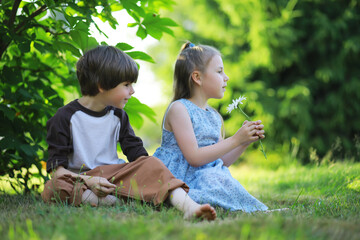 Children walk in the summer in nature. Child on a sunny spring morning in the park. Traveling with children.