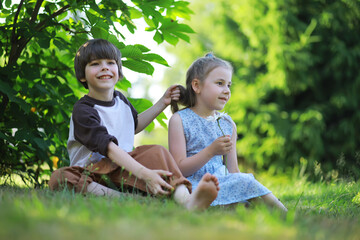 Wall Mural - Children walk in the summer in nature. Child on a sunny spring morning in the park. Traveling with children.