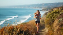 A Woman Enjoys Leisurely Running Along A Coastal Path, Surrounded By The Natural Landscape Of Ocean, Sky, Plants, Beach, And Grass. AIG41