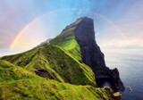 Fototapeta Miasto - Faroe Island in Denmark with rainbow - Kallur lighthouse on green hills of Kalsoy island on sunset time, Landscape photography