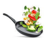 Fototapeta Panele - Frying pan with fresh ingredients in air on white background