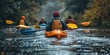 A group of people are pictured paddling down a river in kayaks. This image can be used to depict outdoor recreational activities and team adventures.