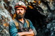 A rugged miner with a hard hat and light poses confidently outside a mine entrance