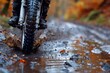 Person Riding Motorcycle Through Puddle of Water