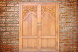 Fototapeta Londyn - carving teak entrance wooden door on vintage wall