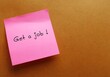 Pink note stick on office envelope with text written GET A JOB ! - concept of first jobber seeking job to begin career, full time employee changing positions or transferring to a new industry