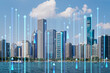 A cityscape with futuristic holographic arrows and binary code overlay, bright daylight, and lake in foreground. Technology and urban concept. Double exposure