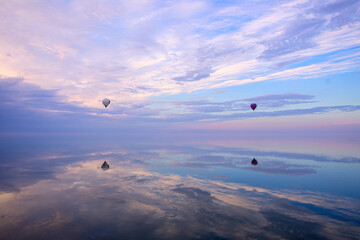 Wall Mural - Skyward Drift: Wind Ball Soars Above Water Against the Sky