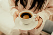 girl hands holding white cup of black coffe. Morning coffee time.