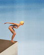 © Lustre Art Group  - Poster. Contemporary art collage. Young athlete woman in retro swimsuit and cap stands on edge of platform to diving to water. Concept of sport, active lifestyle, tournament. Retro effect, art style.