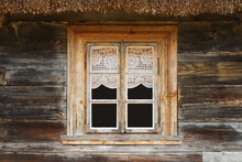 Wooden Rustic Window In Cottage House. Lace Curtains Glass Window Home. Rusty Architecture. Podlasie Region In Poland Vintage Wall. Wood Home Wall Facade. Thatched Roof.