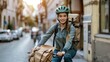 Female courier on a bike with parcels in the city. A woman lucky a parcel to a customer. Delivery