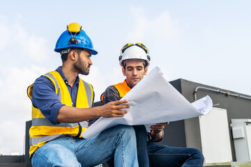 Wall Mural - Two civil engineers sitting and checking information from blueprint with teamwork, project manager planning and collaboration, Builder, inspector, architect, customer, people working at building