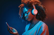 Young beautiful Afro-American woman with headphones enjoying music from smartphone and opening hand.