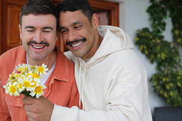 Wall Mural - Man gifting flowers to his handsome boyfriend 