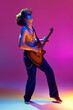 © master1305 - Rock and roll concert. Artistic and emotional shirtless young man playing guitar against pink background in neon light. Concept of music, talent show, performance, concert, festival, instruments