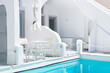 White architecture in Santorini island, Greece. Luxury swimming pool with blue water.