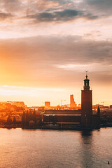 Wall Mural - Stockholm, Sweden. Scenic Skyline View Of Famous Tower Of Stockholm City Hall. Building Of Municipal Council Stands On Kungsholmen Island. Sunshine Above Famous And Popular Place In Sunset Sunrise.