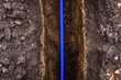 Earth trench dug to lay pipe or optical fiber.