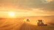 Dynamic angle of a fleet of tractors and combines working in unison to harvest a vast cornfield under the setting sun dust clouds billowing