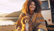 Smiling young woman afro hairstyle under warm plaid meets morning lake view sunrise sitting at touristic camper van with dog friend. Camp traveling concept, Mobile Living Captivating Home on wheels.