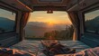 Inside view from a van facing a sunrise over mountains